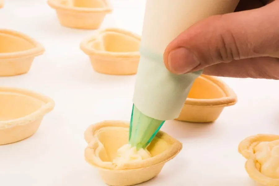 person hand putting white cream heart shape